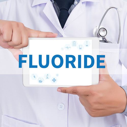 Doctor with Fluoride board