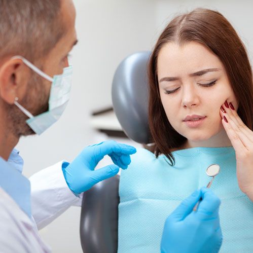 Women consulting to dentist for toothache