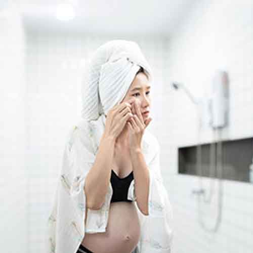 Pregnant women checking acne
