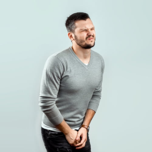 Man holding the urge to urinate